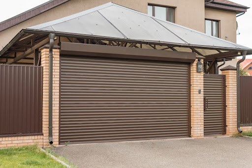 A closed brown garage door in the suburbs