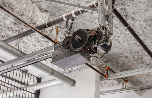 A garage door operator in need of repairs and maintenance