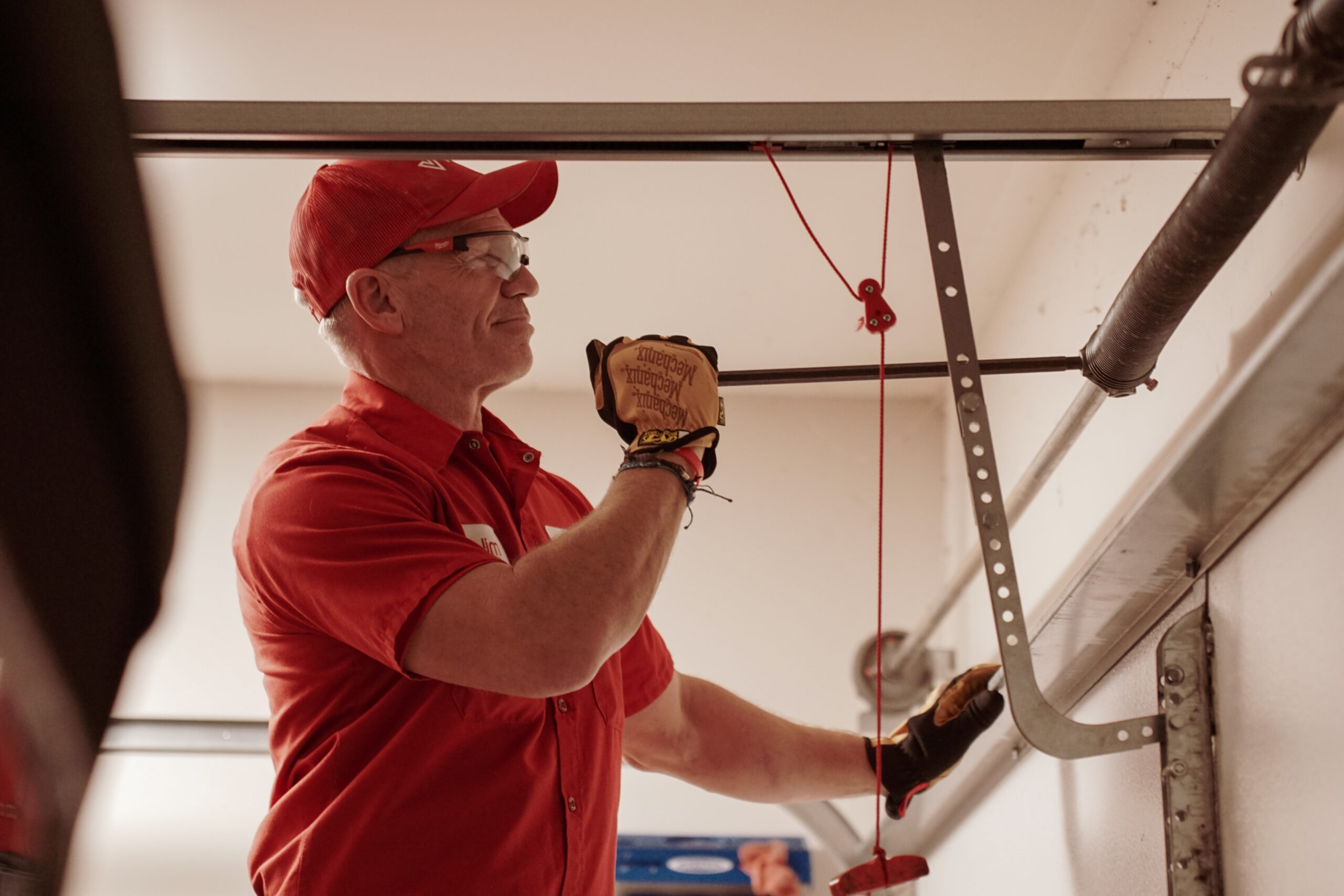 man working on garage door spring