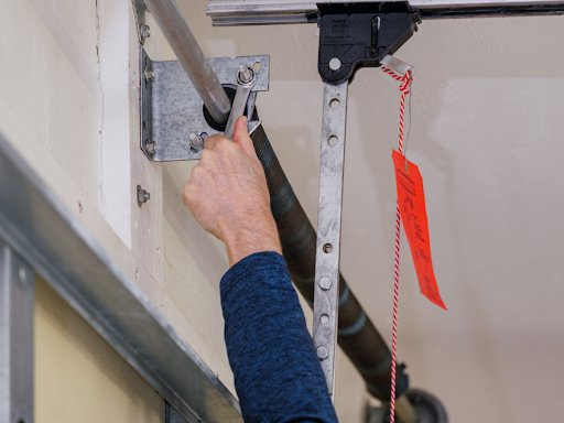 Technician performing residential garage door maintenance